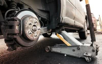 Vorbereitung zum Reifen wechseln: das Auto wird auf den Wagenheben aufgebockt Jeder Reifenwechsel beginnt mit dem Aufbocken auf einen Wagenheber